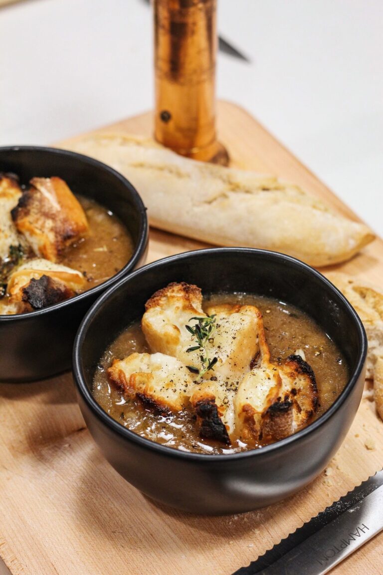 Bowls of French onion soup topped with melted cheese