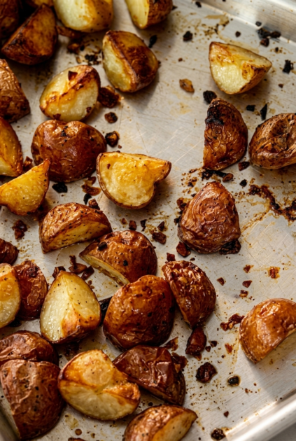 Golden crispy roasted petite potatoes on a baking sheet