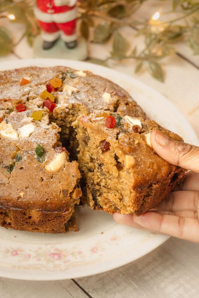 Sliced no-bake icebox fruit cake with cherries, coconut and pecans