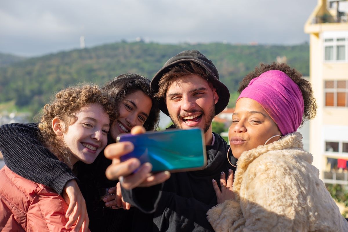 Group of friends taking a selfie together outdoors