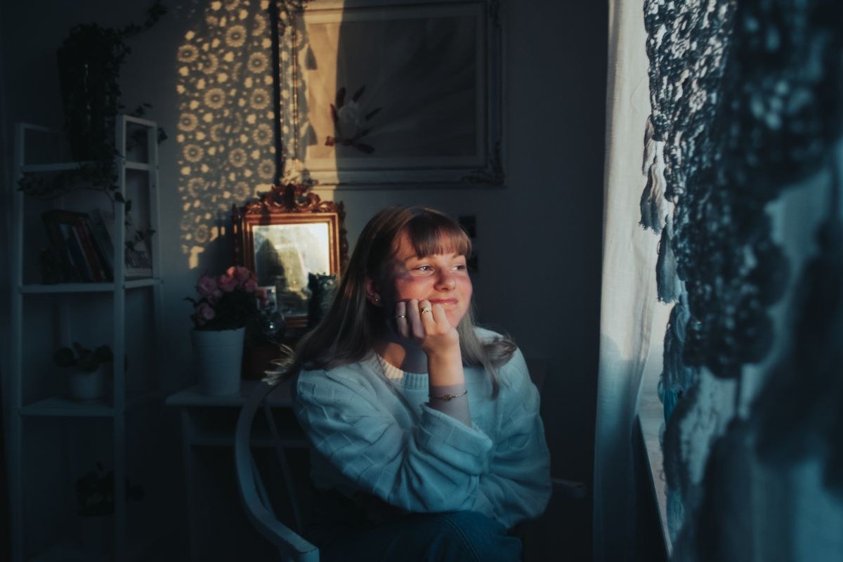 Thoughtful woman gazing out a window