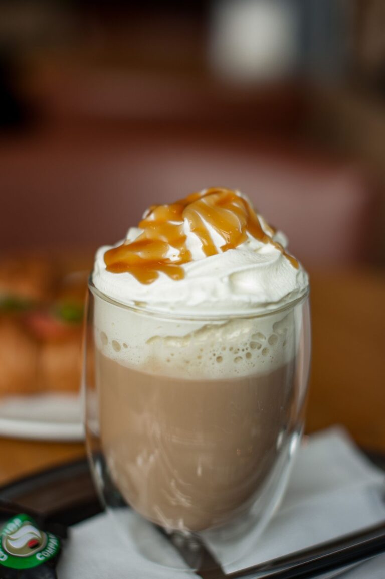 Caramel brulee latte topped with whipped cream and caramel drizzle