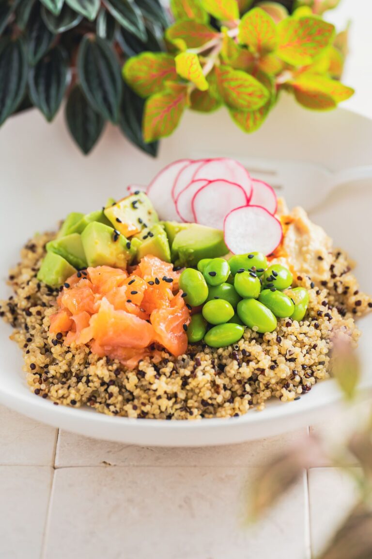 Turmeric salmon bowl with quinoa, roasted sweet potato, greens and avocado